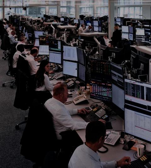 Trading floor with multiple desks and monitors